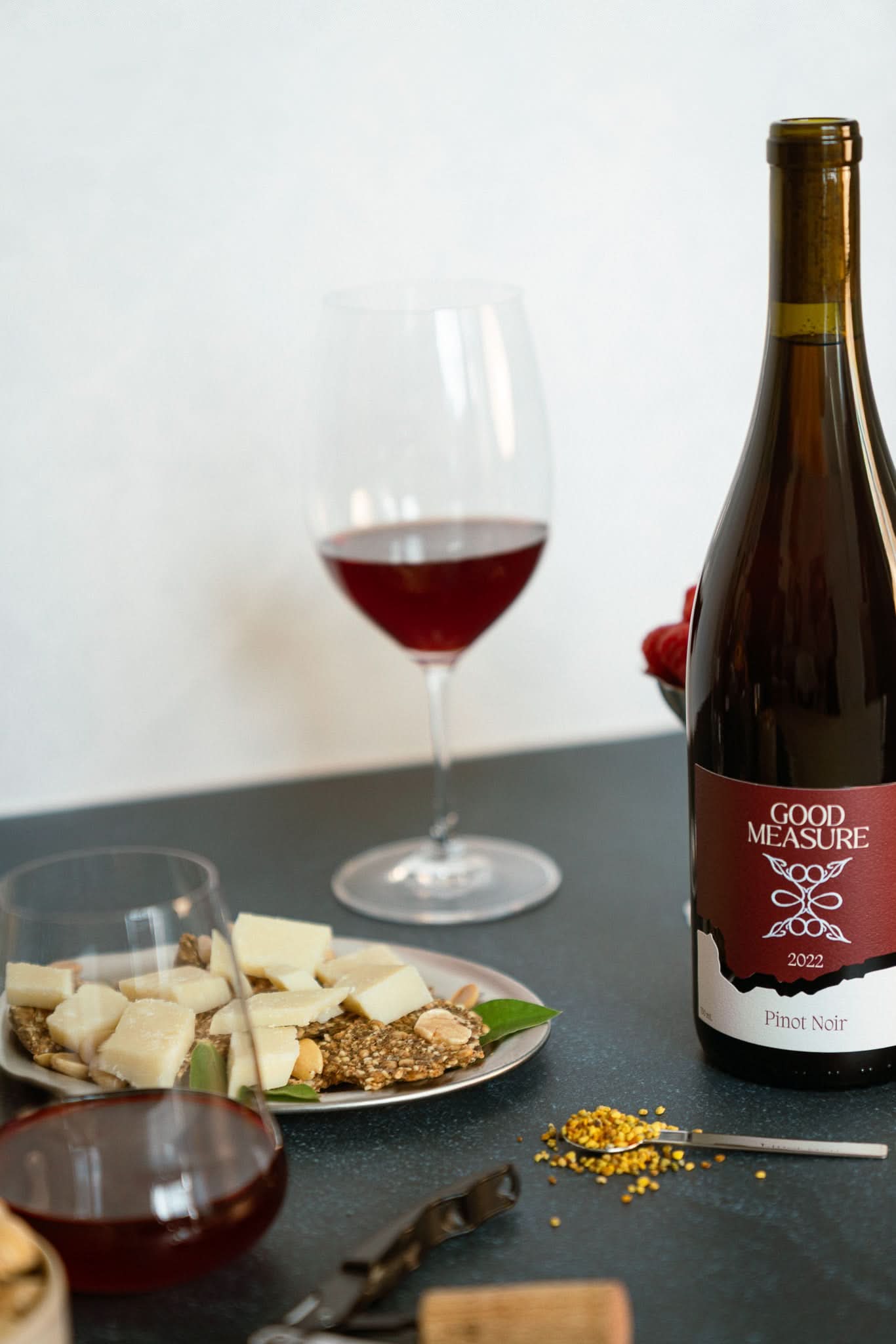 Bottle of Good Measure 2022 Oregon Pinot Noir with burgundy label and glass