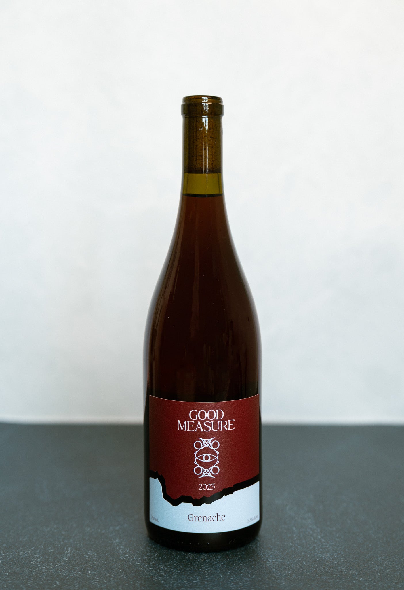Bottle of Good Measure 2023 Oregon Grenache with burgundy and blue label